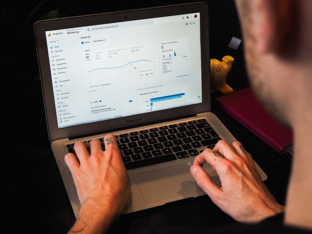 A man using Google Analytics on a laptop.